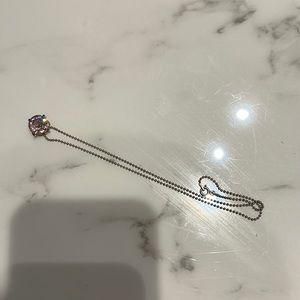 Cute pink necklace. Stone is about the size of my pinky. Super dainty chain.